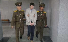 American student Otto Frederick Warmbier (centre) arrives at a court for his trial in Pyongyang.