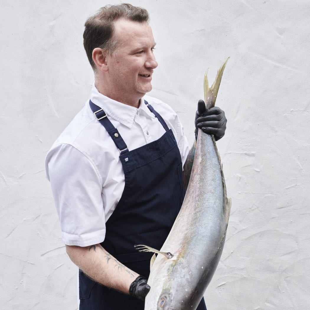 Chef Johnon Macdonald holding a fish.