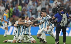 Argentina's forward #10 Lionel Messi  celebrates with teammates after Argentina won the Qatar 2022 World Cup final football match between Argentina and France at Lusail Stadium in Lusail, north of Doha on December 18, 2022.