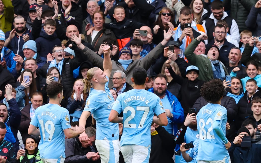 Erling Haaland of Manchester City celebrates scoring his team's third goal during the Premier League match between Manchester City and Luton Town.