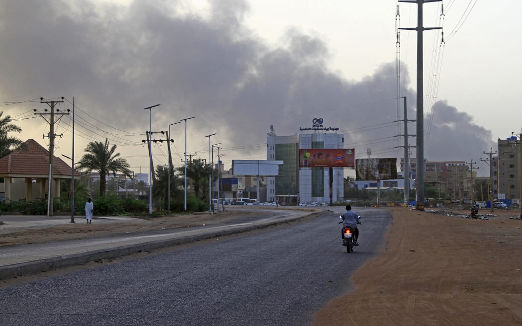Smoke billows above residential buildings in Khartoum on 16 April 2023, as fighting in Sudan raged for a second day in battles between rival generals.