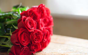Red roses bouquet. Flowers. Romantic background