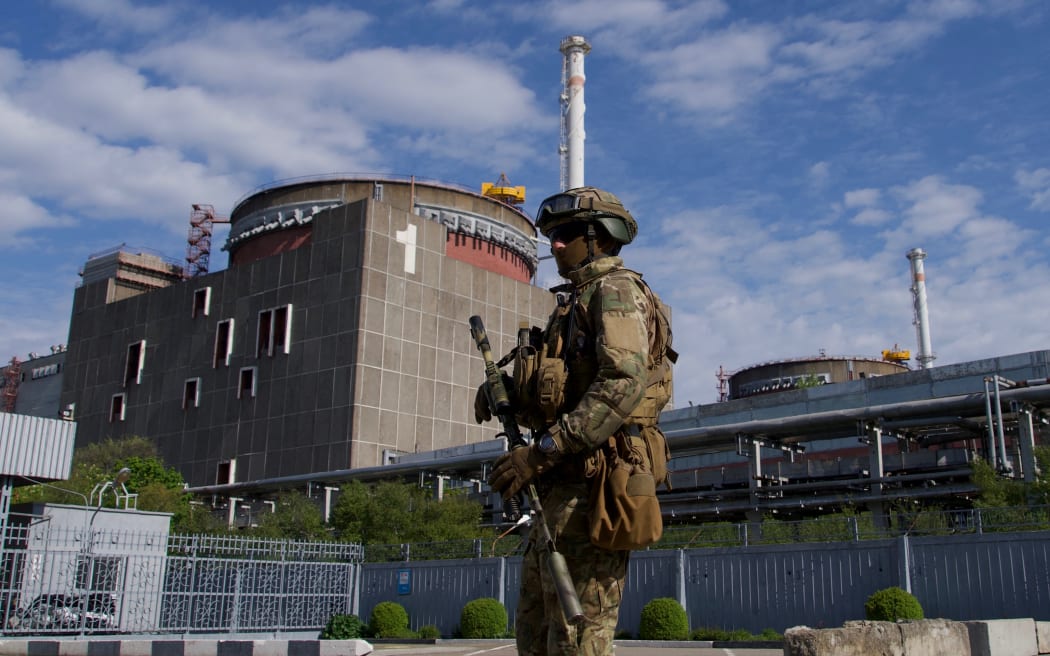 In this file photo taken on 1 May 2022, a Russian serviceman patrols the territory of the Zaporizhzhia nuclear power station in Energodar