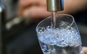 Drinking water running into a glass.