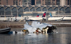WASHINGTON, DC - JANUARY 30: (EDITOR'S NOTE: This Handout image was provided by a third-party organization and may not adhere to Getty Images' editorial policy.) In this U.S. Coast Guard handout, the Coast Guard investigates aircraft wreckage on the Potomac River on January 30, 2025 in Washington, DC. An American Airlines flight from Wichita, Kansas collided midair with a military Black Hawk helicopter while on approach to Ronald Reagan Washington National Airport outside of Washington, DC. According to reports, there were no survivors among the 67 people onboard both aircraft.   Petty Officer 1st Class Brandon Giles/ U.S. Coast Guard via Getty Images/AFP (Photo by Handout / GETTY IMAGES NORTH AMERICA / Getty Images via AFP)