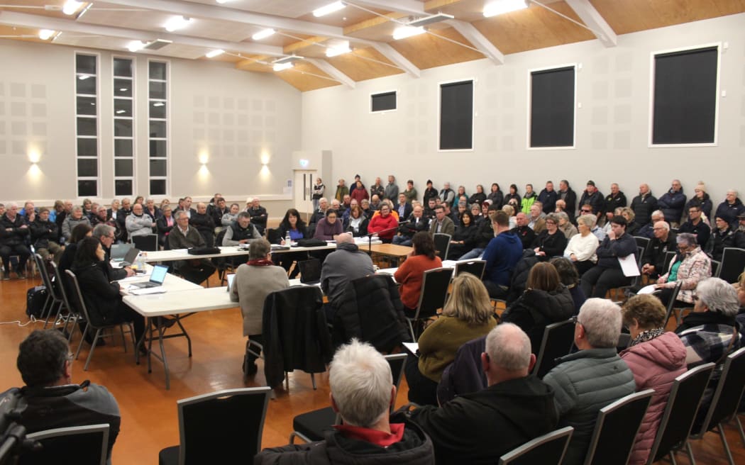 More than 100 people packed into Winton Memorial Hall on Monday evening for what turned out to be chair Colin Smith's last day on the job.