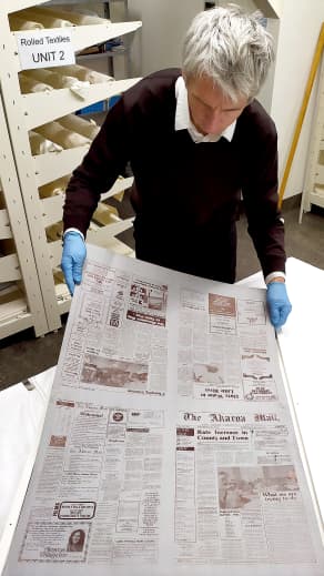 Akaroa Museum collections manager Daniel Smith prepares a printing plate for the display at the Museum.
