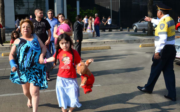 People leaving buildings in Mexico City on Friday morning.