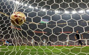 France's forward #10 Kylian Mbappe (2R) scores a penalty goal during the Qatar 2022 World Cup final football match between Argentina and France at Lusail Stadium in Lusail, north of Doha on December 18, 2022.