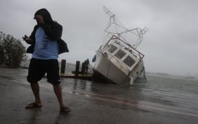 A boat is washed on shore at the Watson Island marina as Hurricane Irma passed through the area.