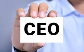 Card with CEO (Chief Executive Officer) held by a man's hand