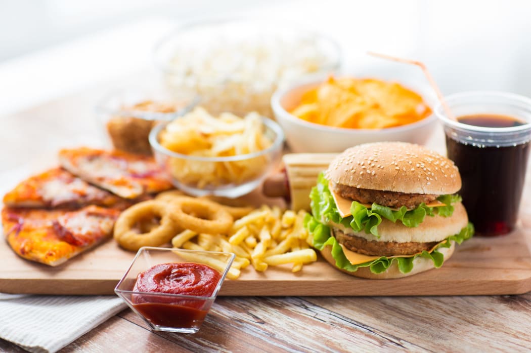Close up of fast food snacks and drink on table.