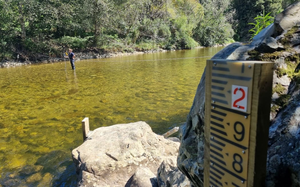 Hydrology manager Samwell Warren measuring the baseline flows in the river with a cable. The dry summer has seen rivers levels running low.