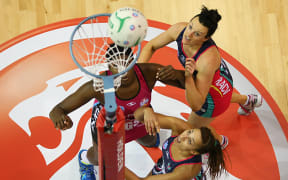 Southern Steel's Jhaniele Fowler-Reid, left, takes a shot at goal while Vixens Bianca Chatfield and Geva Mentor wait for a rebound.