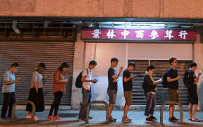 People queue to cast their vote during the district council elections in Tseung Kwan O district in Hong Kong.
