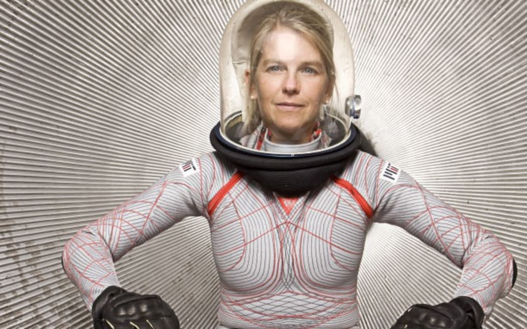 Dr Dava Newman modelling her Biosuit. The biosuit is a tight, form fitting spacesuit with a clear bubble helmet.