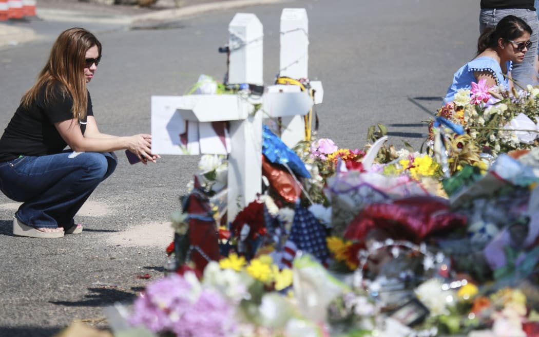 EL PASO, TX - AUGUST 15: People gather at a makeshift memorial honoring victims outside Walmart August 15, 2019 in El Paso, Texas. 22 people were killed in the Walmart during a mass shooting on August 3rd.