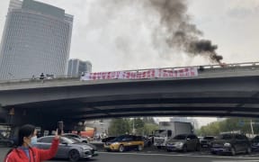 A rare protest occurred in Beijing ahead of the Chinese Communist Party congress. Text on the banner includes: 'Depose the Traitorous Dictator Xi Jinping’ and 'We Want Votes, Not Leaders; We Want Dignity, Not Lies; We are Citizens, not Slaves.'