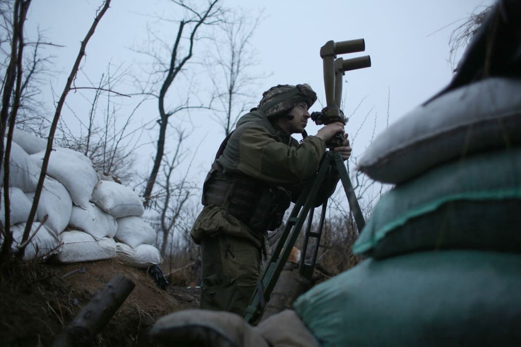 A Ukrainian serviceman is seen in the shelter at the front line position not far from Donetsk town, which is not under the control of the Ukrainian government, on 28 November 2021.