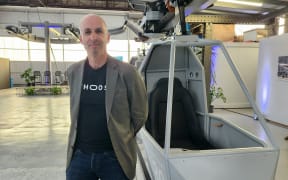 Whoosh head Dr Chris Allington beside a prototype Whoosh vehicle in Christchurch