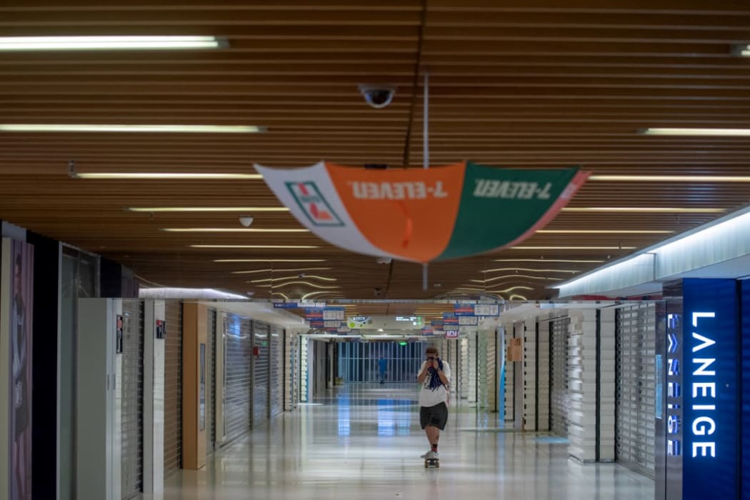 An umbrella is hung to block a CCTV camera in a shopping mall in Tai Po district during a general strike in Hong Kong on August 5, 2019.