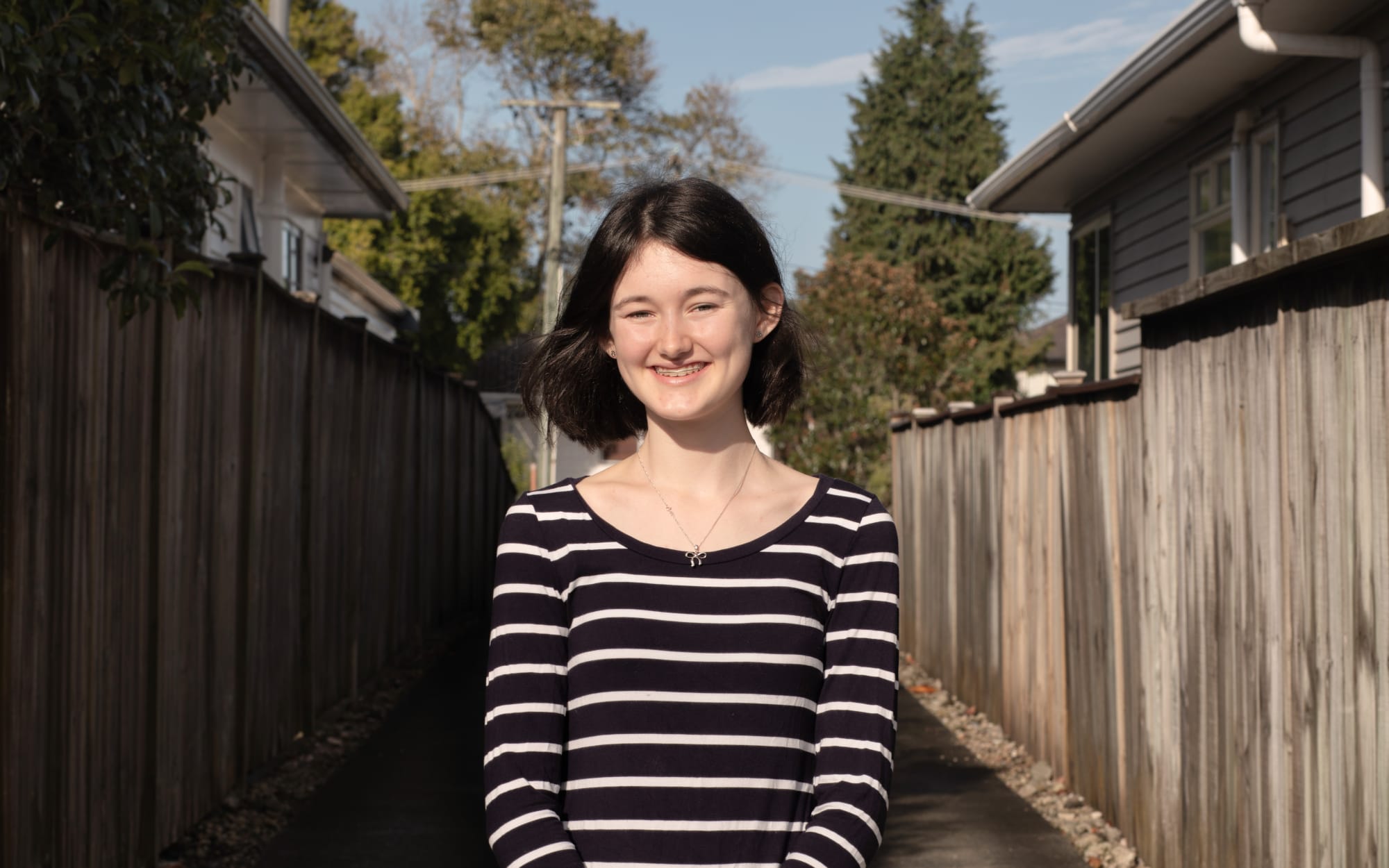 Portraits of people in lockdown. Student Bree Felton photographed outside her home during lockdown Level 3.
