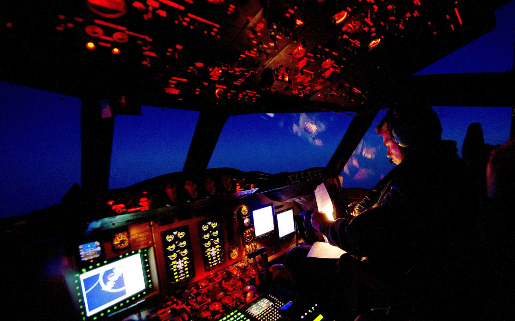 Royal New Zealand Air Force aircrew on the flight deck of the P-3K2 Orion over the southern Indian Ocean.