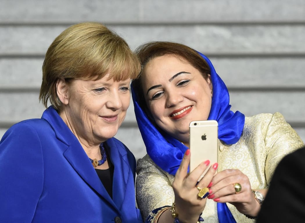 Afghan politician Shukria Barakzai (R) takes a selfie photograph together with German Chancellor Angela Merkel after a so-called G7 women dialog forum at the German Chancellery in Berlin, on 16 September 2015.