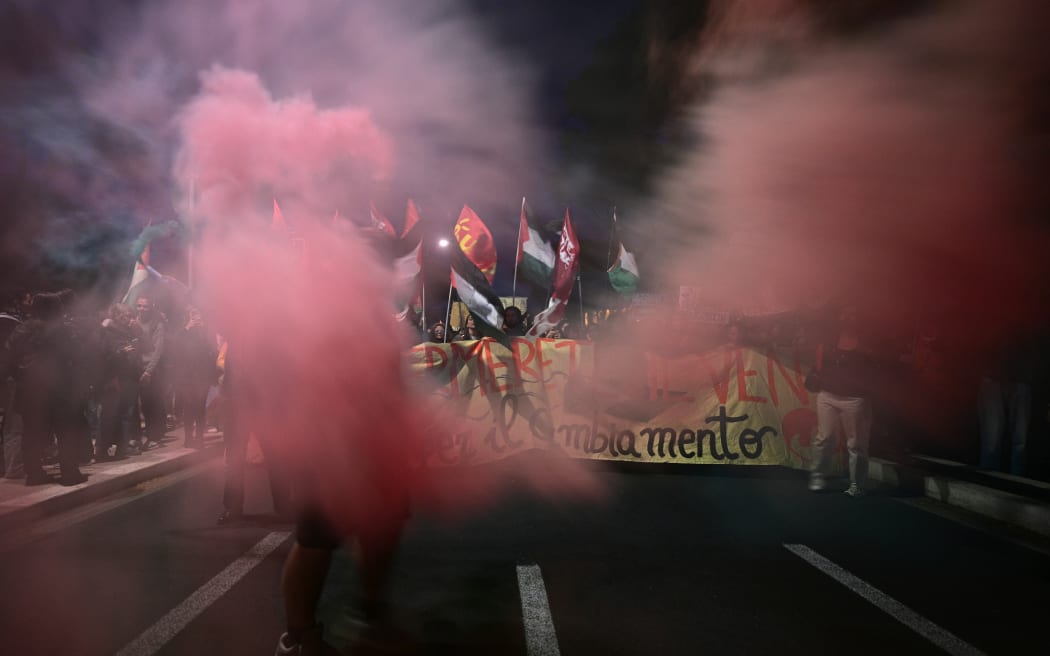 Pro-Palestinian demonstrators use smoke bombs as they march to support the Palestinians and to protest against the interception of the Global Sumud Flotilla, near the Colosseum in Rome.