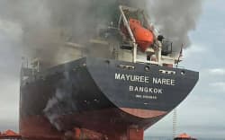 This handout photo taken on March 11, 2026 and released by the Royal Thai Navy shows smoke rising from the Thai bulk carrier ‘Mayuree Naree’ near the Strait of Hormuz after an attack. A Thai bulk carrier travelling in the crucial Strait of Hormuz was attacked March 11, with 20 crew members rescued so far, the Thai navy said.