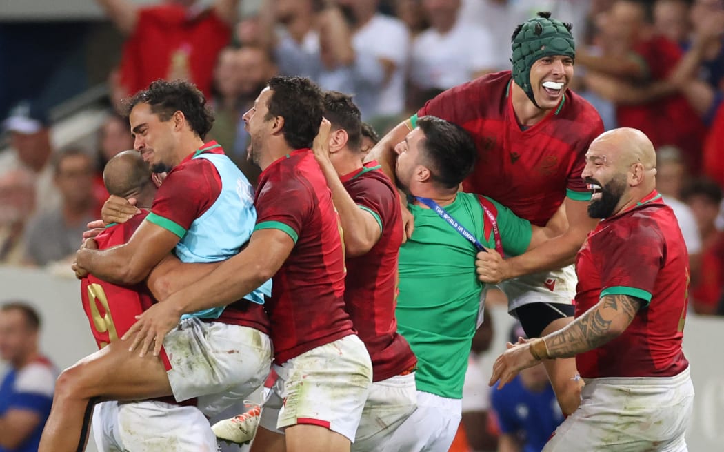 Portugal's flanker David Wallis (second right) and Portugal's hooker Mike Tadjer (right) celebrate with teammates after victory in the France 2023 Rugby World Cup Pool C match between Fiji and Portugal at the Stade de Toulouse in Toulouse, southwestern France on October 8, 2023.