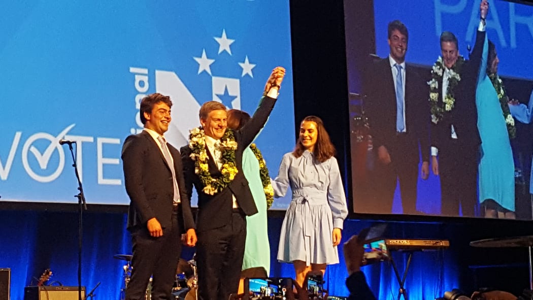 Bill English with his son Xavier, wife Mary (hidden) and daughter Maria.