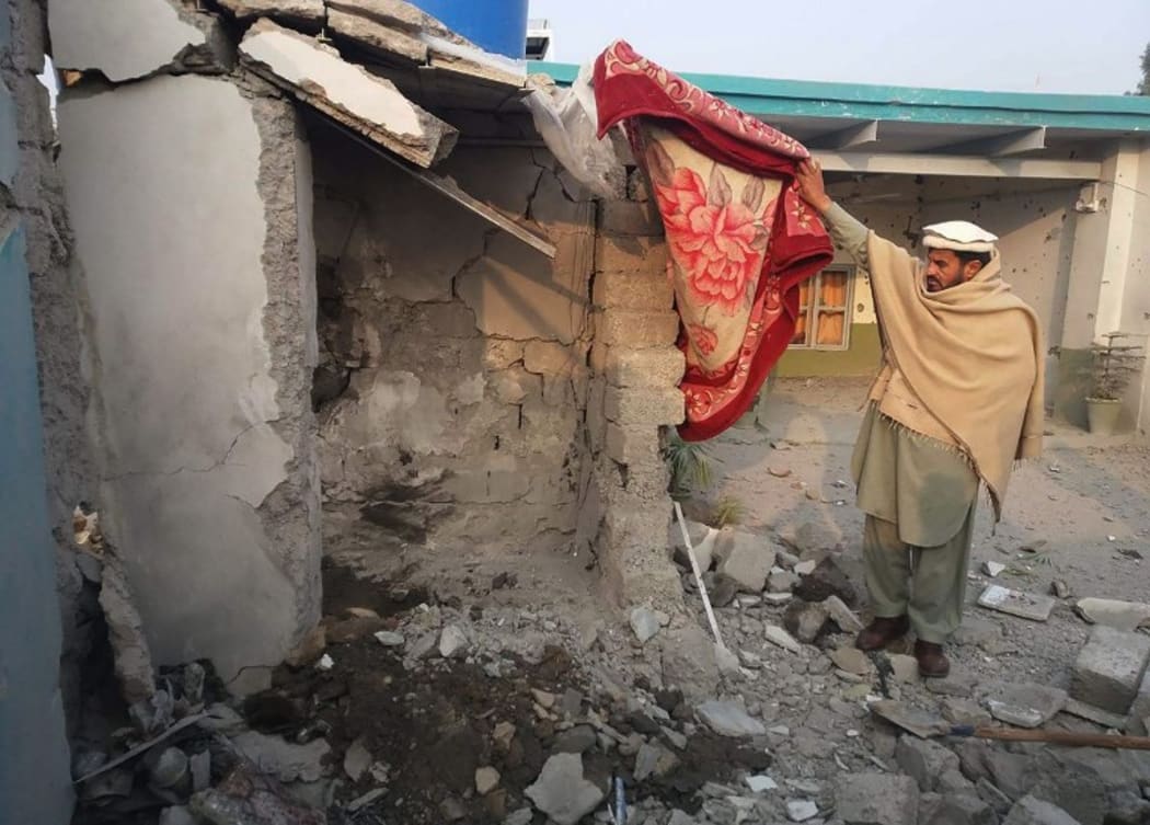 A Pakistani tribesman inspects the site of a drone strike in Mamuzai in the Kurram tribal district.