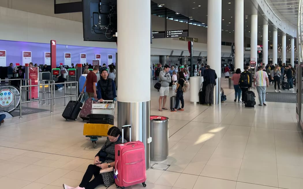 Passengers wait at Perth Airport, where all flights have been cancelled due to a refuelling problem, on 1 June 2024.