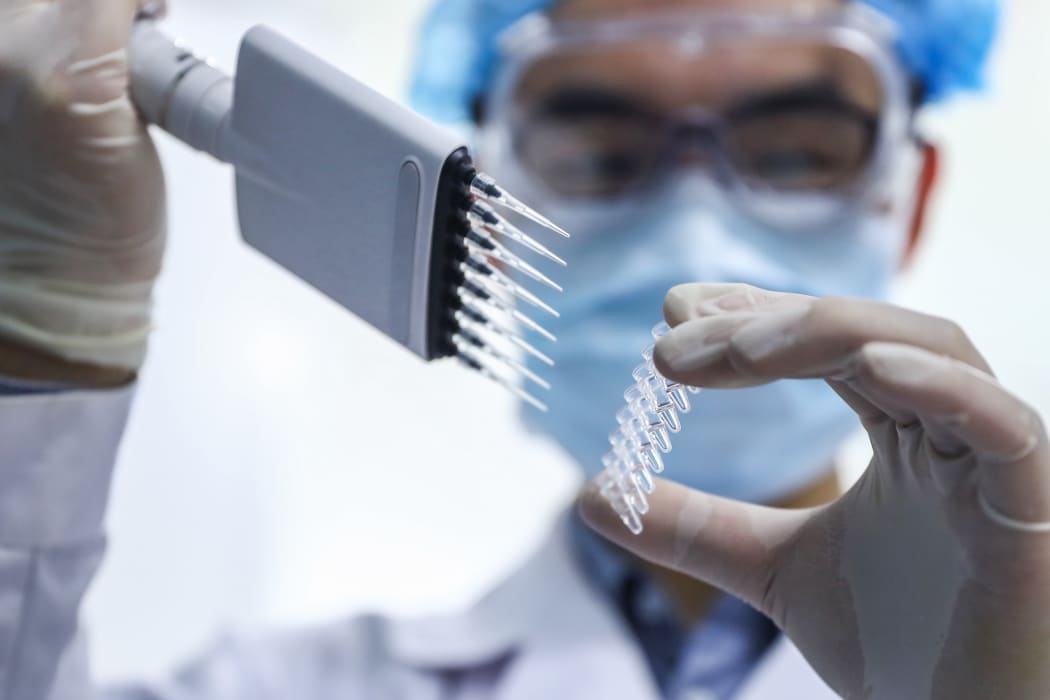 (200414) -- BEIJING, April 14, 2020 (Xinhua) -- A staff member tests samples of the COVID-19 inactivated vaccine at a vaccine production plant of China National Pharmaceutical Group (Sinopharm) in Beijing, capital of China, April 11, 2020.