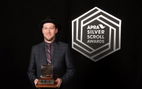 Thomas Oliver with his award, the 2016 Apra Silver Scroll