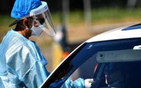 A health worker takes a swab sample for Covid-19 testing in Sydney.
