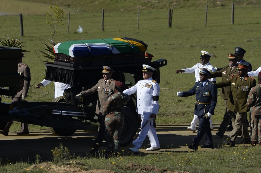 The coffin of Nelson Mandela is escorted as it arrives for the funeral ceremony.