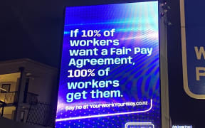 A billboard from Business NZ on Fair Pay Agreements legislation.