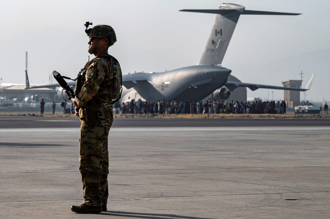 In this image courtesy of the US Air Force,, maintains a security cordon around a US Air Force C-17 Globemaster III aircraft in support of Operation Allies Refuge at Hamid Karzai International Airport (HKIA), Kabul, Afghanistan, on August 20, 2021.