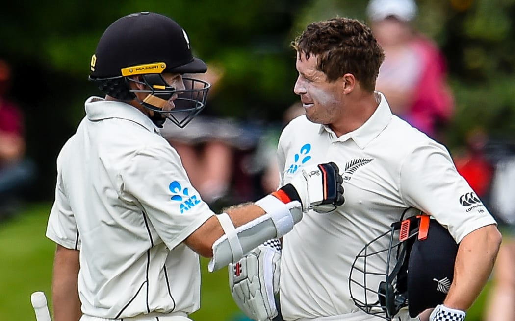 Tom Latham (left) congratulates Henry Nicholls on scoring a century against Sri Lanka.