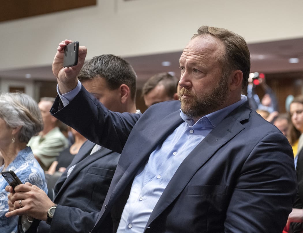 "Infowars" host Alex Jones makes his own recording as he attends the United States Senate Select Committee on Intelligence hearing "to examine foreign influence operations' use of social media platforms" on Capitol Hill in Washington, DC.