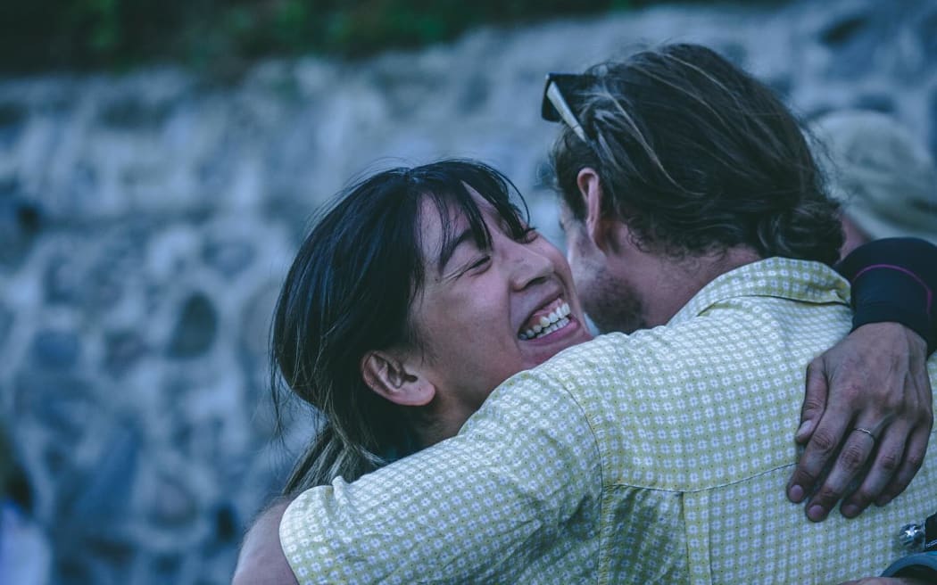 New Zealand team members Elissa Mah and Josh Evans embrace at the Downhill Skateboarding World Championships.