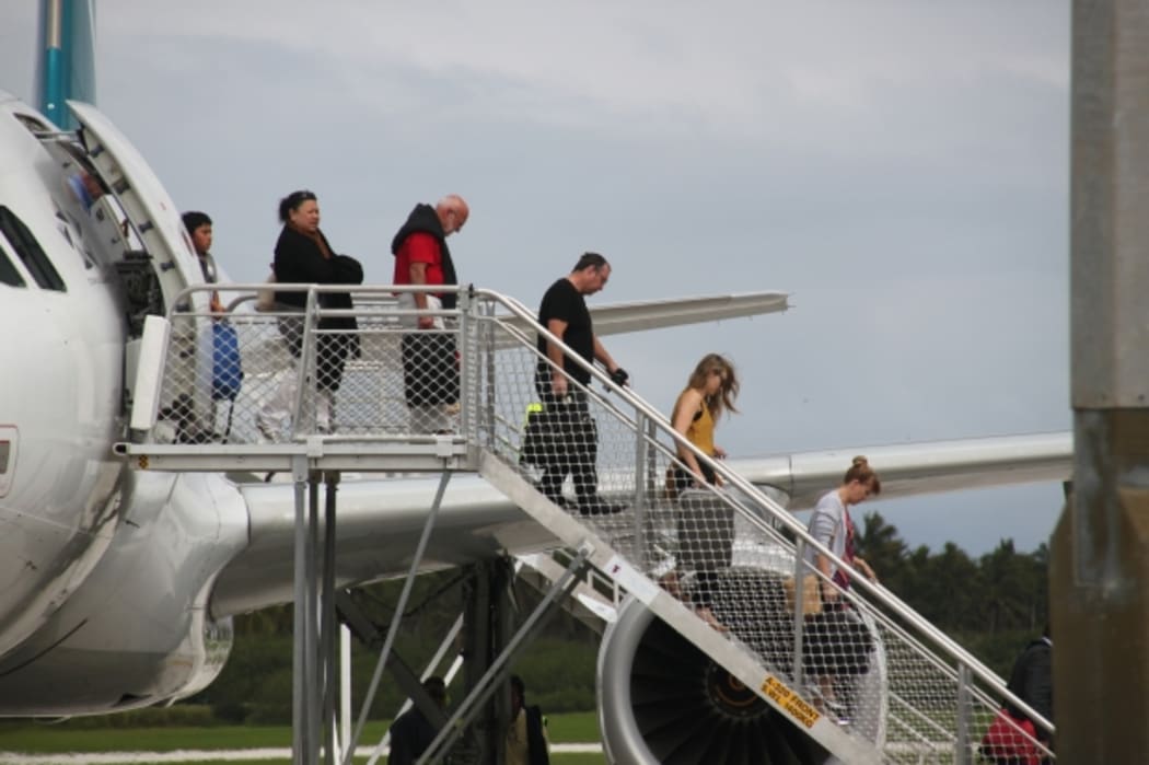 people disembarking plane