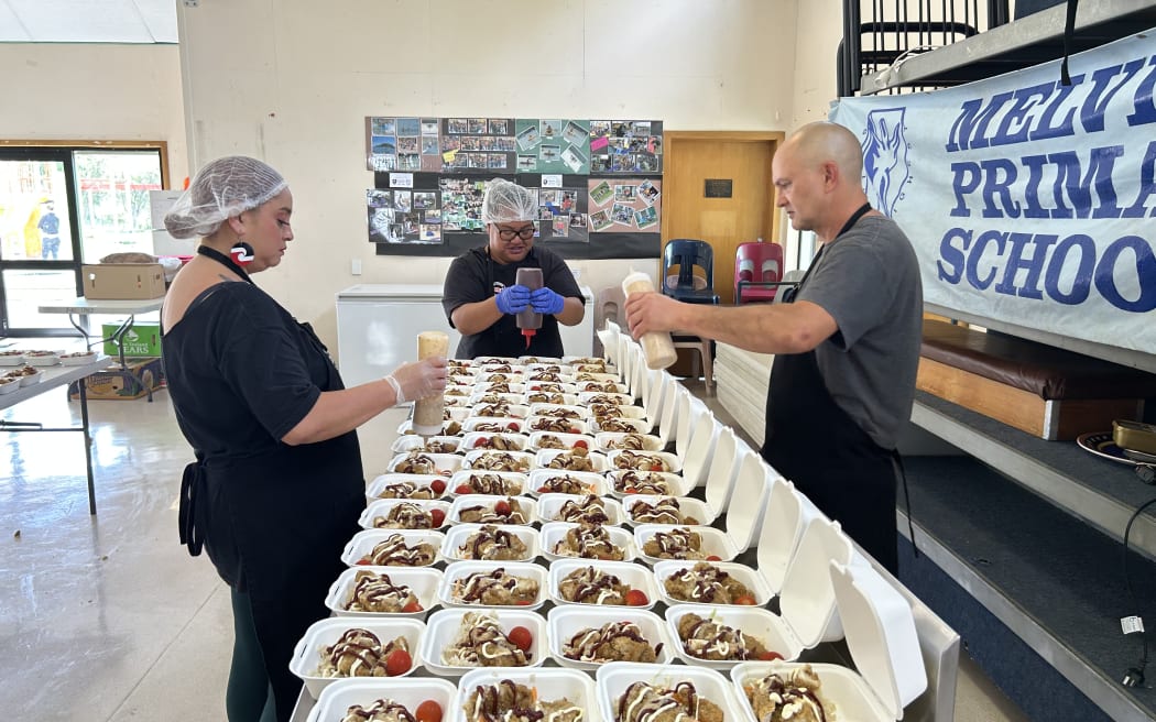 The kitchen staff are preparing food for Melville Primary School pupils.
