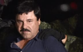 Drug kingpin Joaquin "El Chapo" Guzman is escorted into a helicopter at Mexico City's airport on January 8, 2016 following his recapture during an intense military operation in Los Mochis, in Sinaloa State.