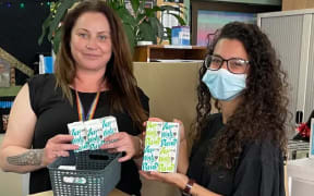 Kōkiri Marae Sexual & Reproductive Health Promoter/Educator Shelley Duffin (left) holdin period care products.