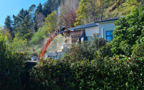 Nicola and Barry McKay's red-stickered home being demolished.