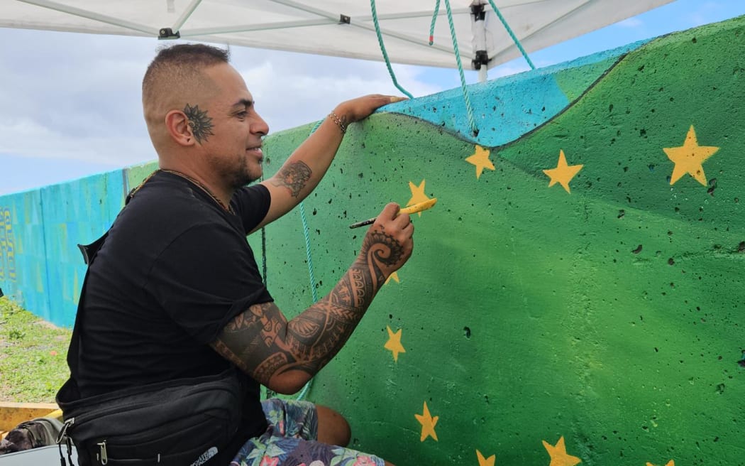 The artist Gonzalo Aldana completes the finishing touches the day before the grand opening.