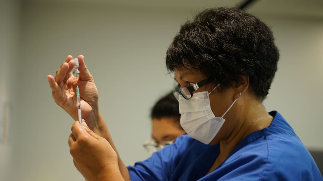 A vaccinator prepares one of New Zealand's first Covid-19 vaccinations on 19 February.